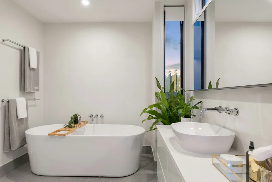 Light bathroom with freestanding bath and a long vanity